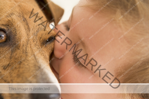 Baby kissing dog